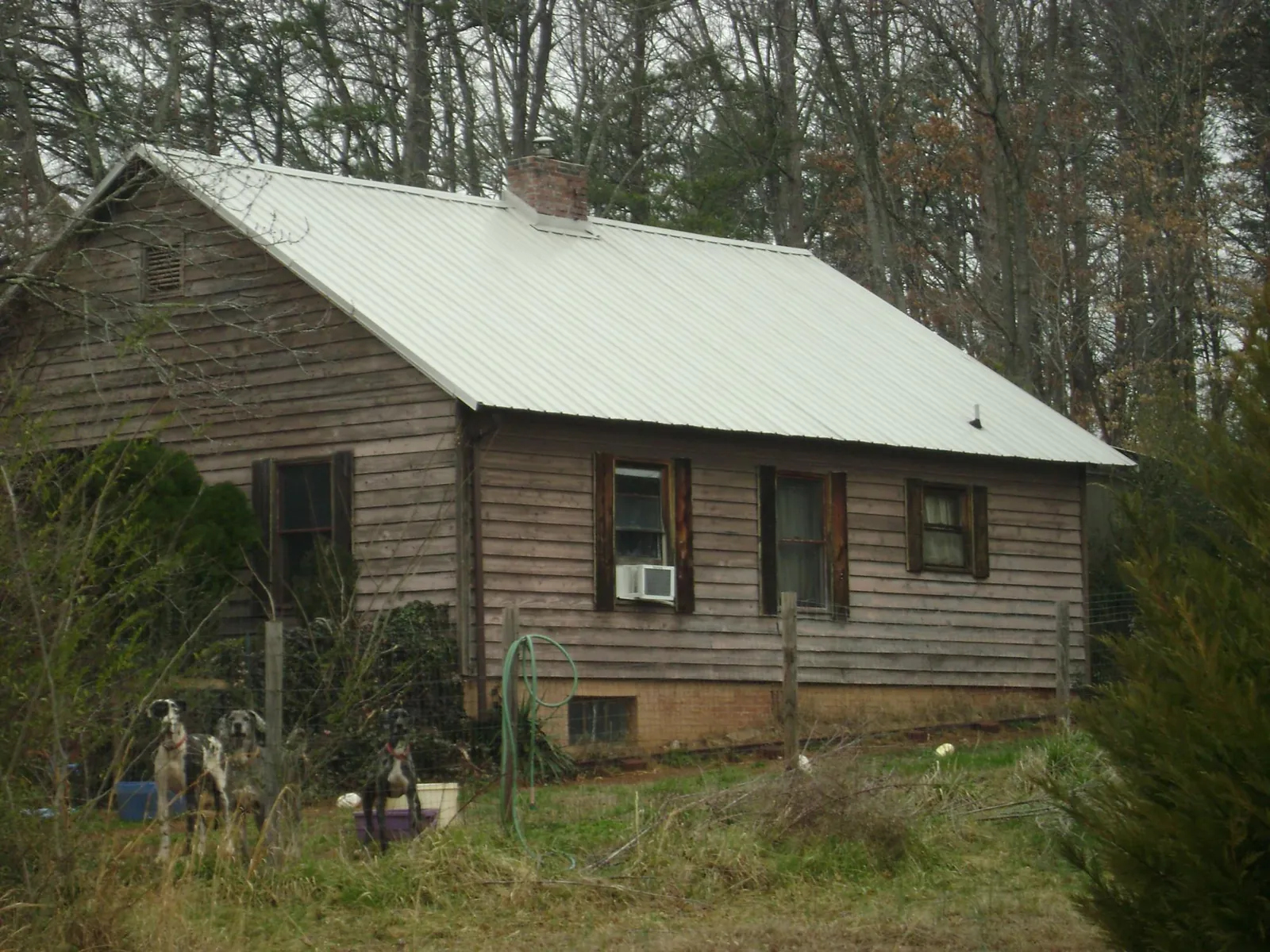 White metal roof on an old wood sided farmhouse, from a Metal Roof Installation job in Idaho City